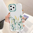 a woman holding a phone case with flowers on it