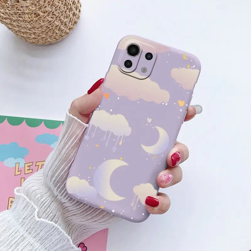 a woman holding a phone case with a unicorn pattern