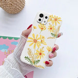 a woman holding a phone case with flowers on it