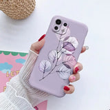 a woman holding a phone case with a flower design