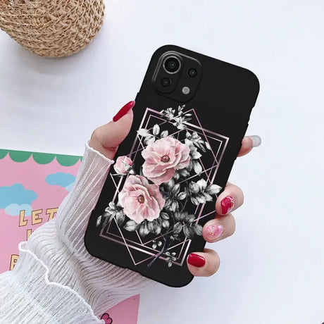 a woman holding a phone case with flowers on it