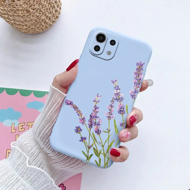 a woman holding a phone case with lavender flowers on it