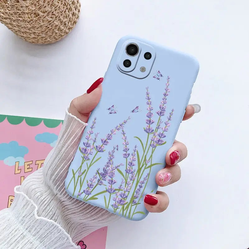 a woman holding a phone case with lavender flowers on it
