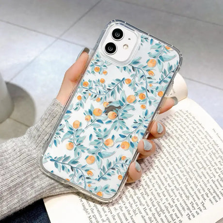 a woman holding a phone case with a floral pattern