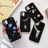 a woman holding a phone case with a space theme