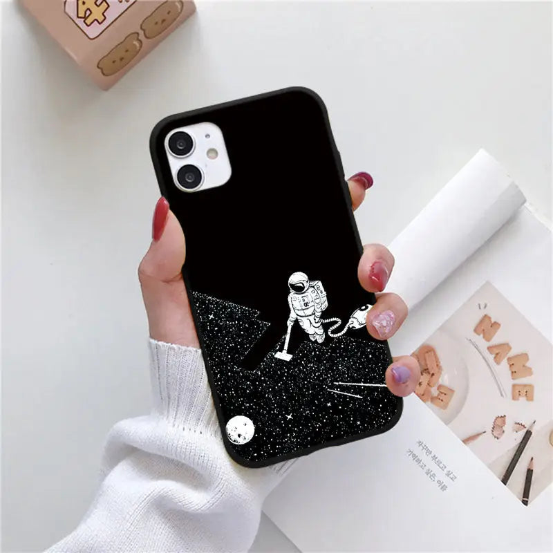 a woman holding a phone case with a black and white image of a girl on a starr background