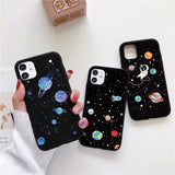 a woman holding a phone case with planets and stars