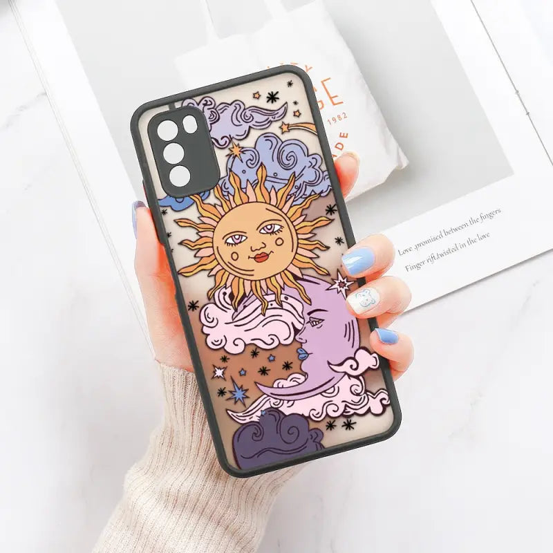 a woman holding a phone case with a cartoon sun and moon