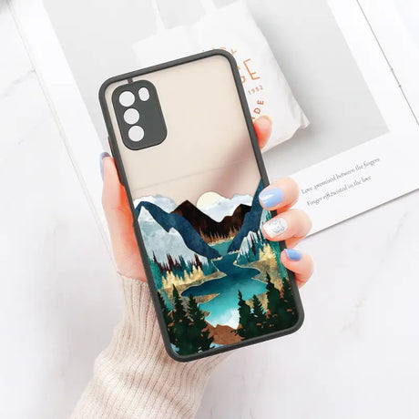 a woman holding a phone case with a mountain scene