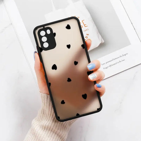 a woman holding a phone case with hearts on it