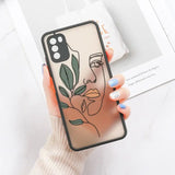 a woman holding a phone case with a plant on it