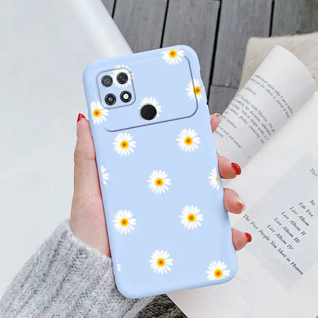 someone holding a phone case with daisies on it