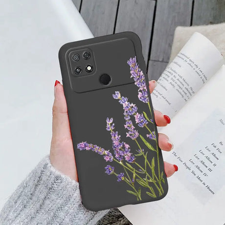 a woman holding a phone case with a purple flower on it