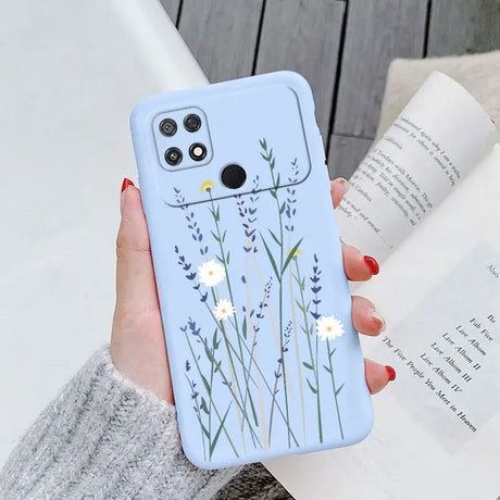 a woman holding a phone case with flowers on it