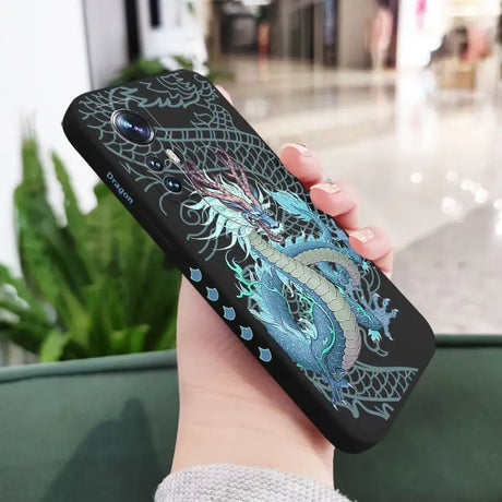 a woman holding a phone case with a dragon design