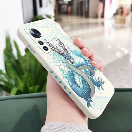 a woman holding a phone case with a dragon on it