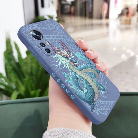 a woman holding a phone case with a dragon on it