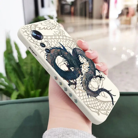 a woman holding a phone case with a dragon design