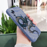 a woman holding a phone case with a dragon on it