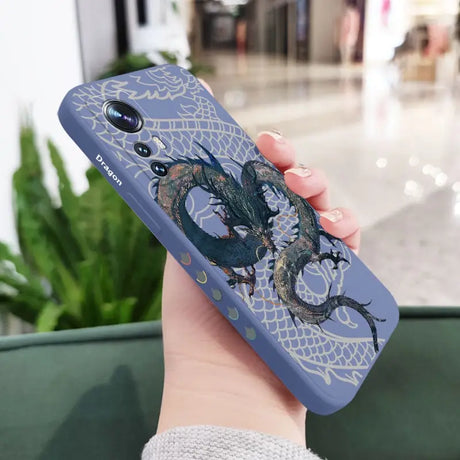 a woman holding a phone case with a dragon on it