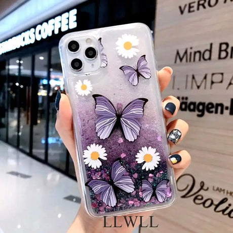 a woman holding a phone case with purple butterflies on it