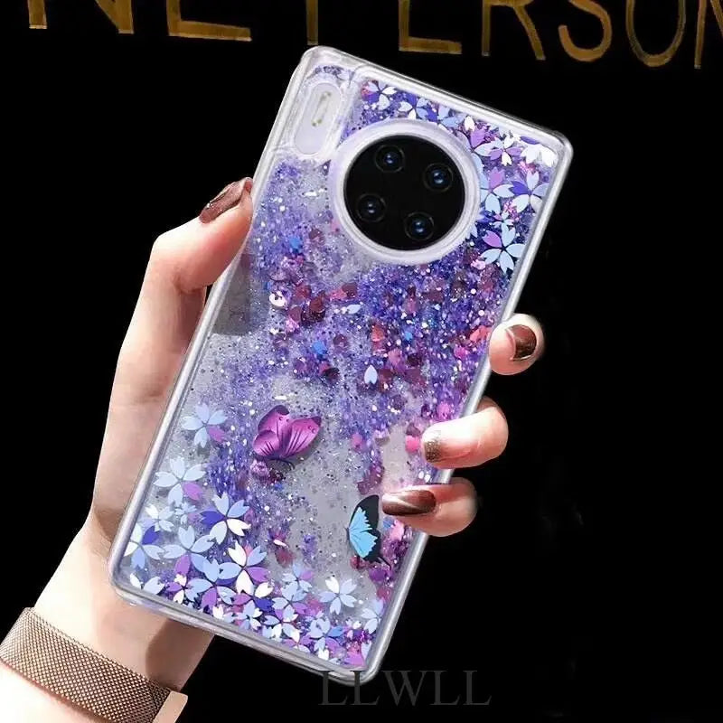 a woman holding a phone case with purple glitter