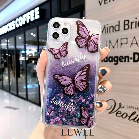 a woman holding a phone case with purple butterflies on it