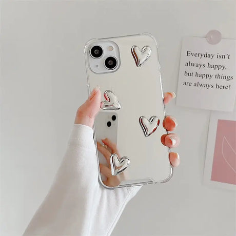 a woman holding a phone case with a heart design