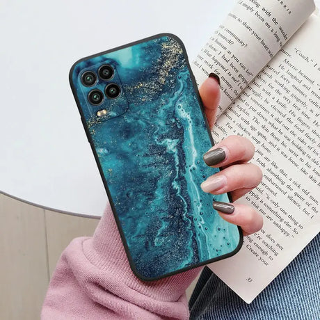 a woman holding a phone case with a blue marble pattern