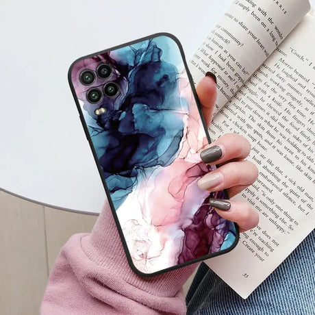 a woman holding a book and holding a phone case