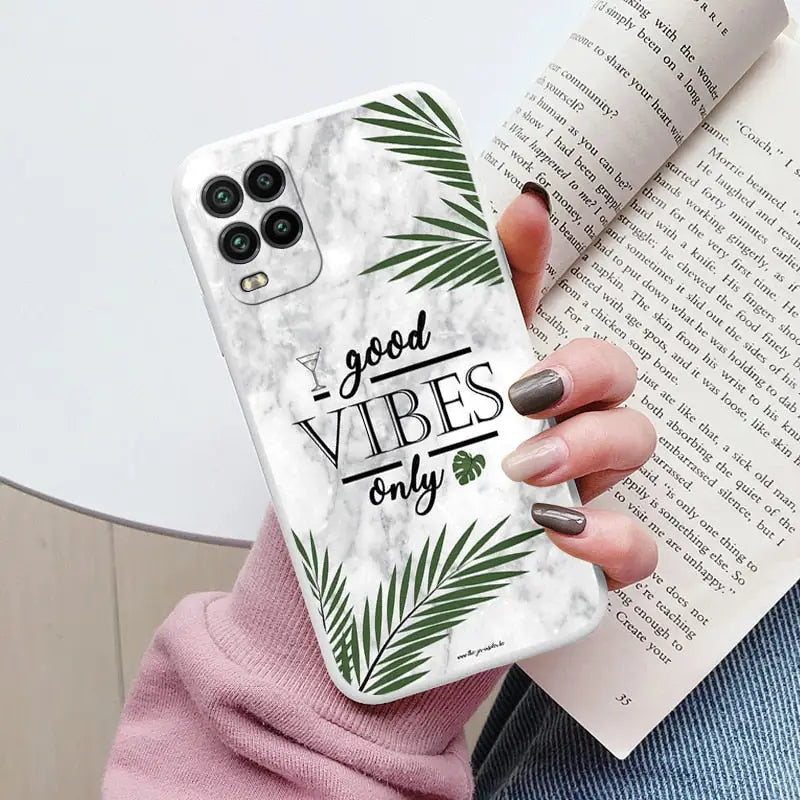 a woman holding a phone case with the words vibes on it