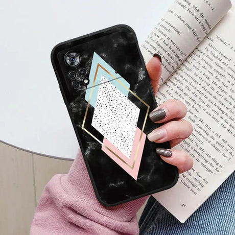 someone holding a phone case with a geometric design on it