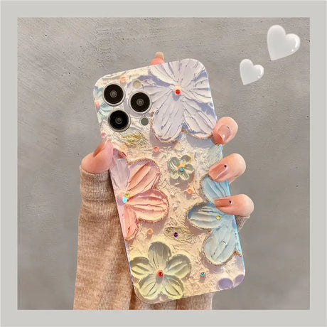 a woman holding a phone case with flowers on it