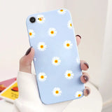 someone holding a phone with a daisy pattern on it