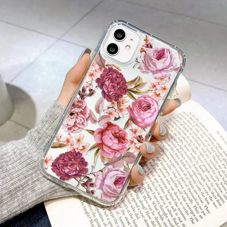 a woman holding a phone case with flowers on it