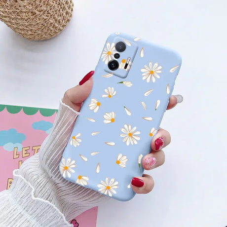 someone holding a phone case with a flower pattern on it