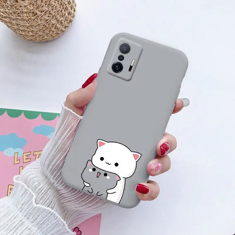 a woman holding a phone case with a cat on it