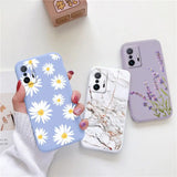 a woman holding a phone case with white flowers on it