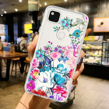 a woman holding up a phone case with flowers on it