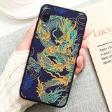 a woman holding a phone case with a dragon design