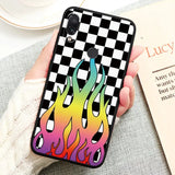 a woman holding a phone case with a colorful fire design
