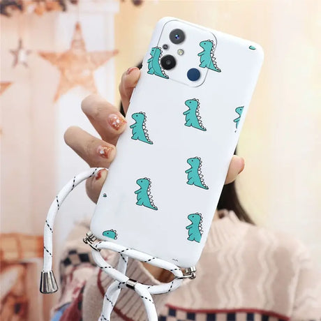 a woman holding a phone case with a green dinosaur pattern