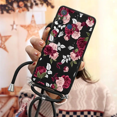 a woman holding a phone case with flowers on it