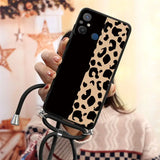 a woman holding a phone case with a black and white cow print