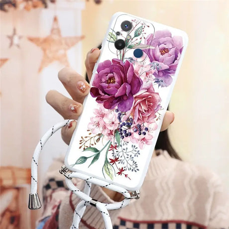 a woman holding a phone case with flowers on it