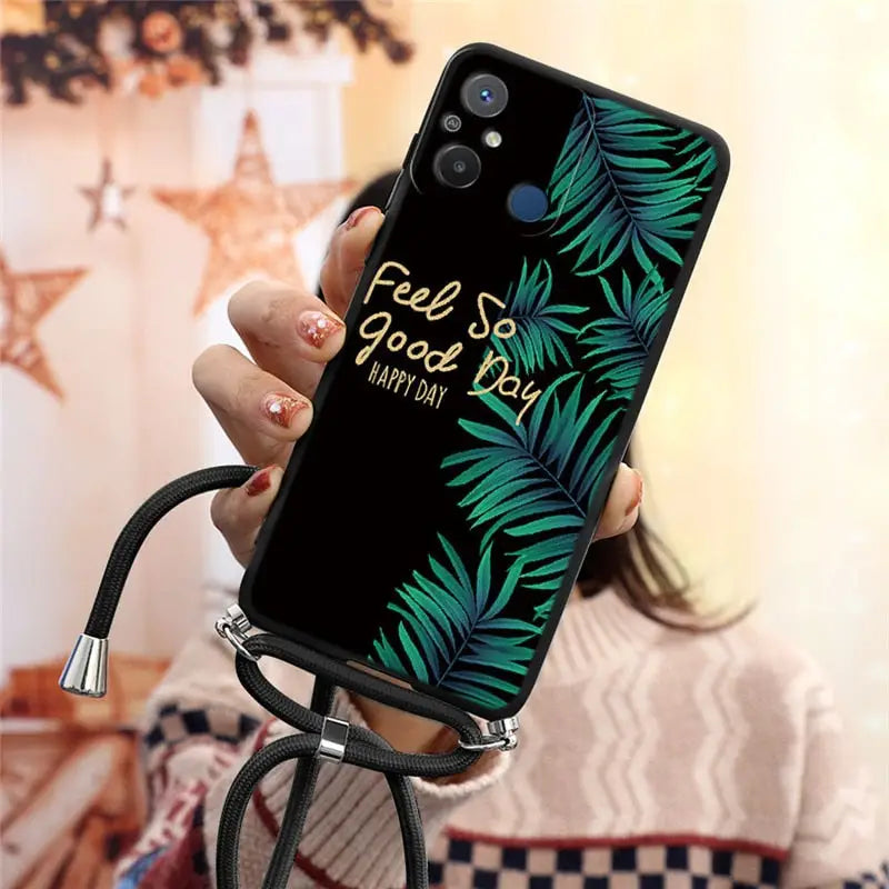a woman holding a phone case with a tropical print