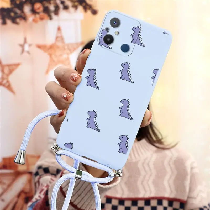 a woman holding a phone case with a pattern on it