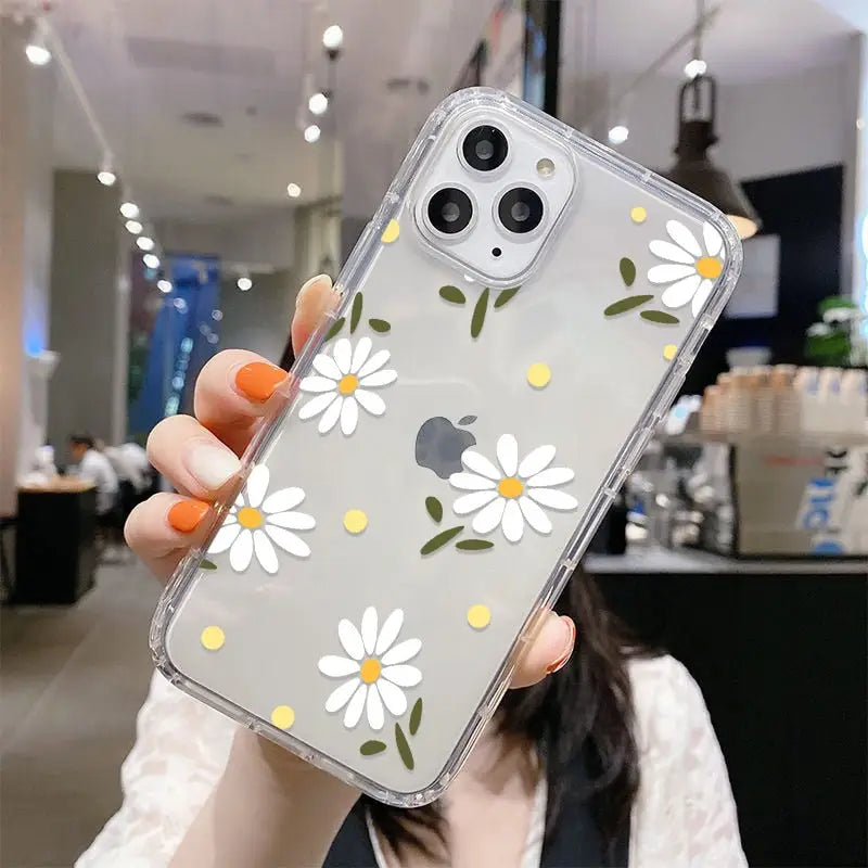someone holding a phone case with a flower design on it