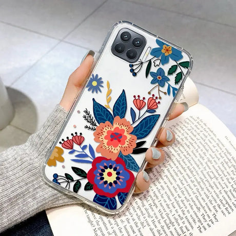 a woman holding a phone case with flowers on it