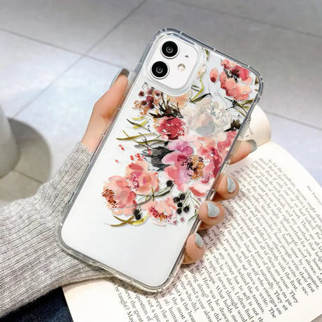 a woman holding a phone case with flowers on it